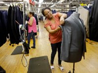 Quality control workers perform a final inspection of complete suits before they are shipped out, at the Joseph Abboud manufacturing plant in New Bedford, MA.   [ PETER PEREIRA/THE STANDARD-TIMES/SCMG ]